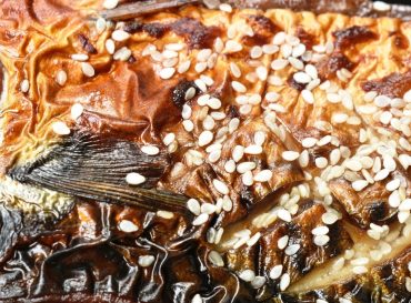 grilled Saba fish or mackerel with sweet black soy sauce topping white sesame on plate