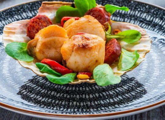 Spiced scallops with chorizo and chili in shell