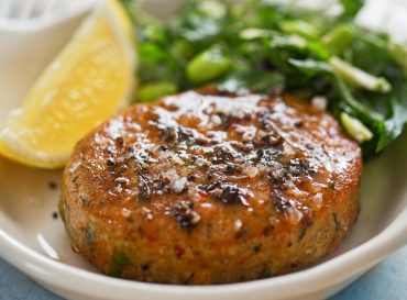 Thai style fish cakes with spicy soy glaze, green salad and lemon wedge