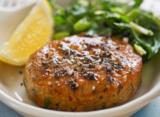 Thai style fish cakes with spicy soy glaze, green salad and lemon wedge
