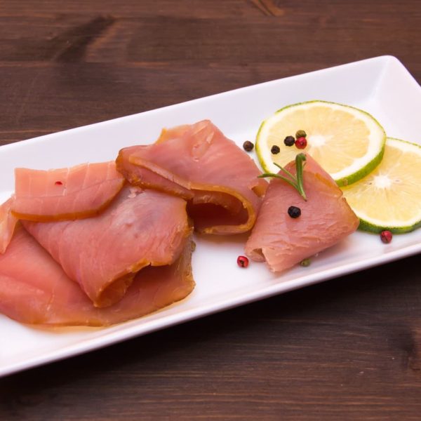 Smoked tuna on tray on wooden table